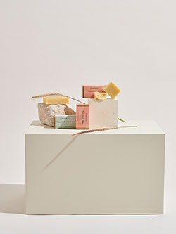 A box with soap and various items on top.